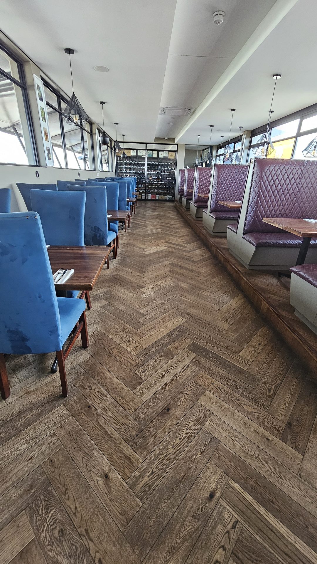 Blue velvet chairs and herringbone floor