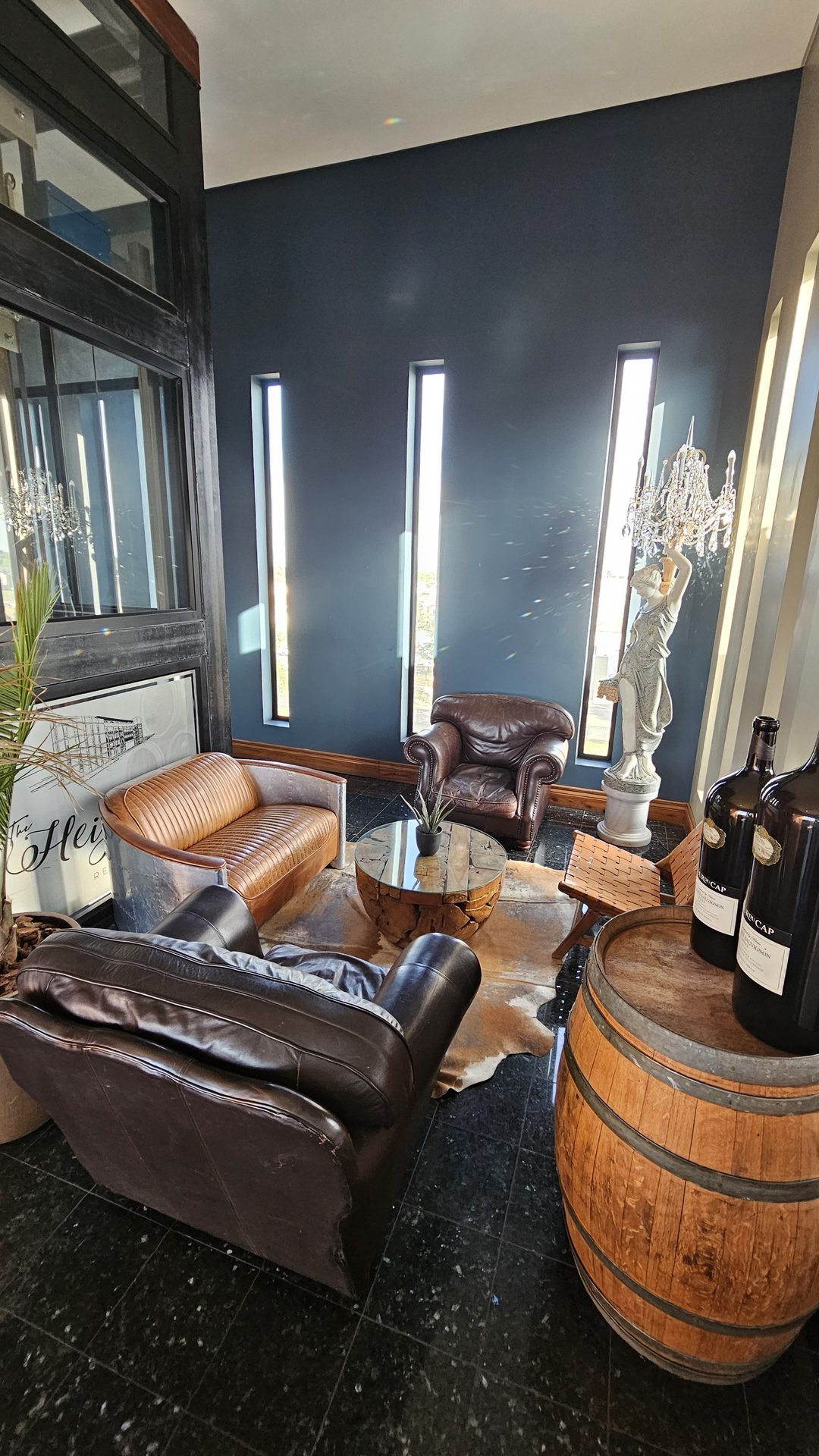 Lounge entrance with leather wing-back chairs and a wine barrel